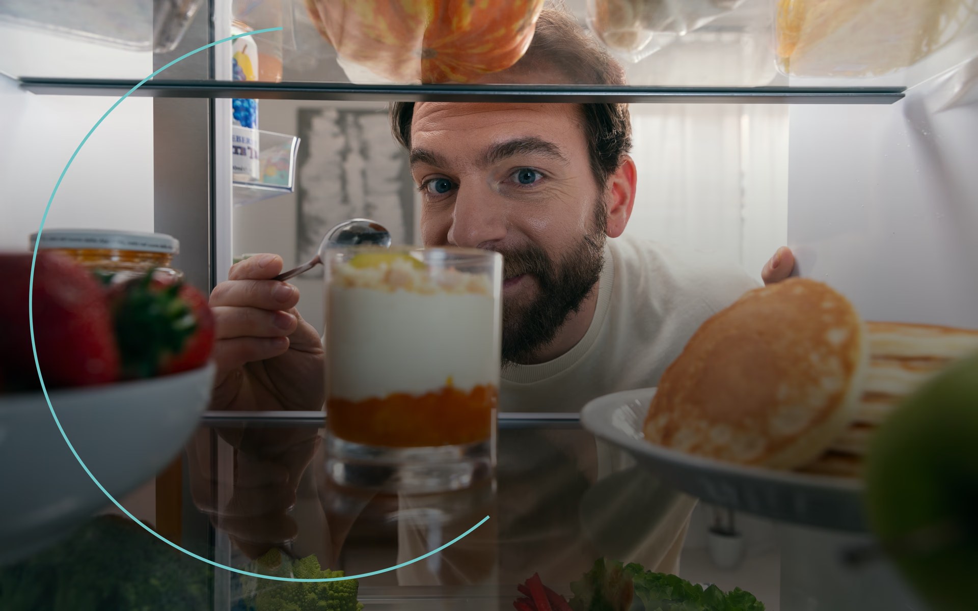 View from inside a Candy fridge as a man reaches in
