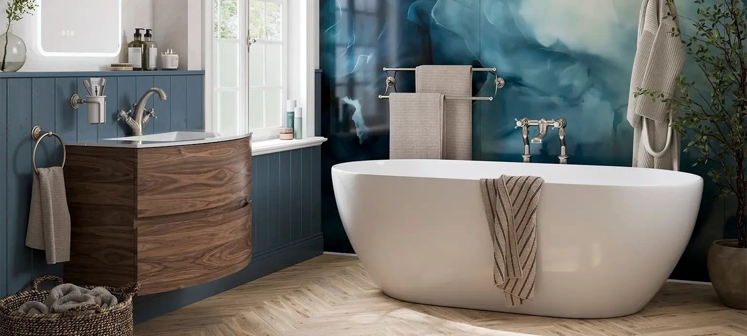 Crosswater bathroom with a freestanding bath and timber effect vanity unit against blue tiles