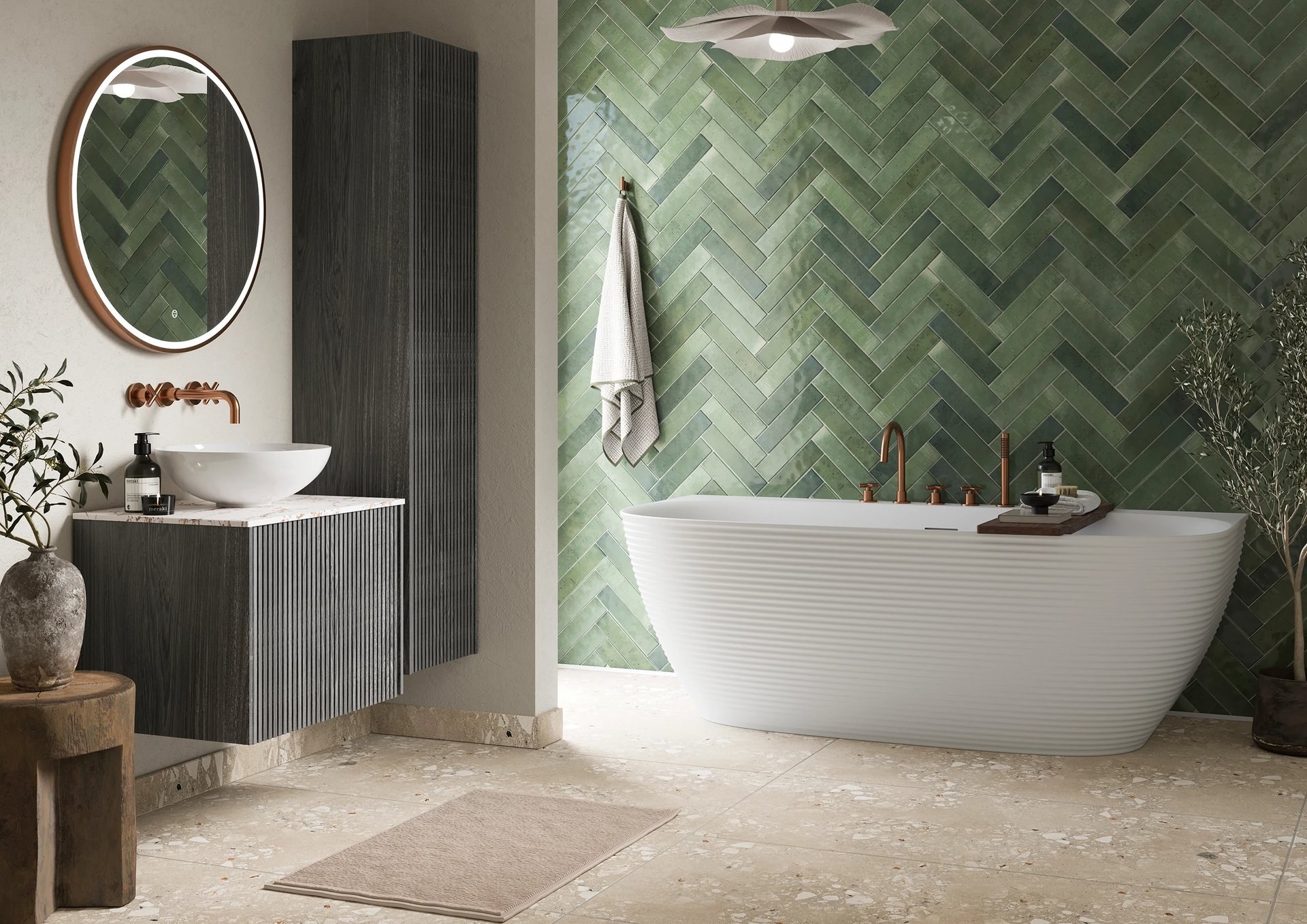 Crosswater freestanding bath in a green herringbone tiled bathroom with a round mirror