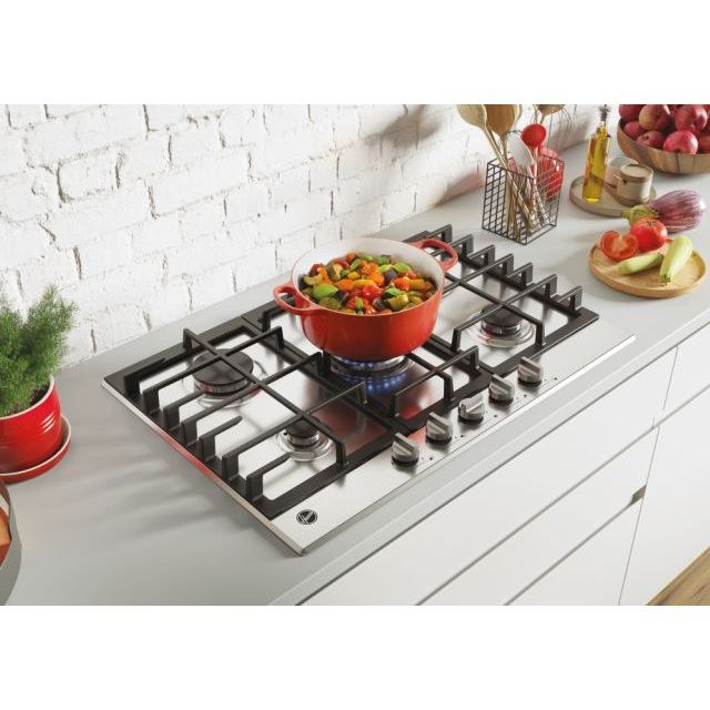 Hoover gas hob with a pan of vegetables on a white worktop