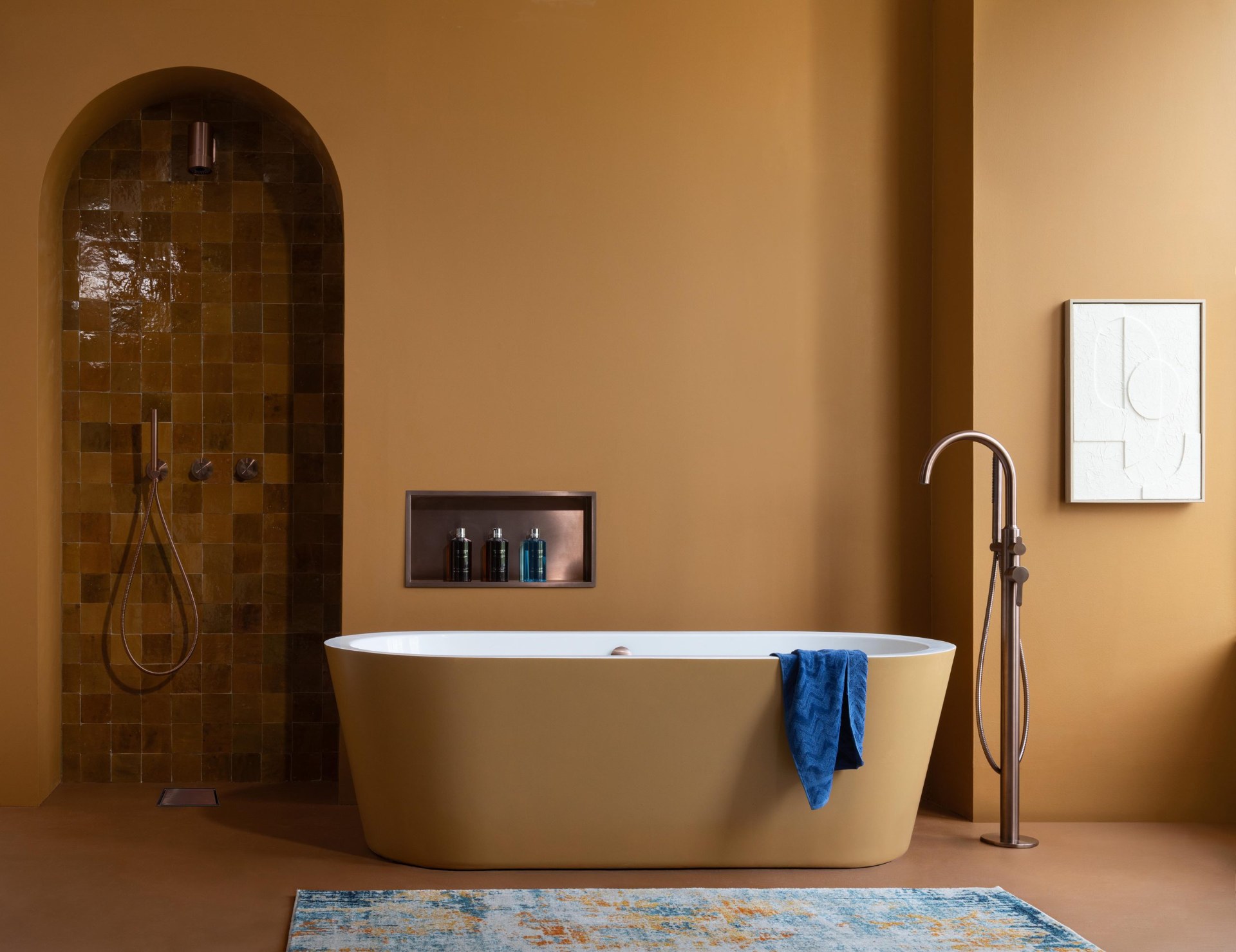 Bathroom with an arched alcove and freestanding bath, fitted with JTP brassware