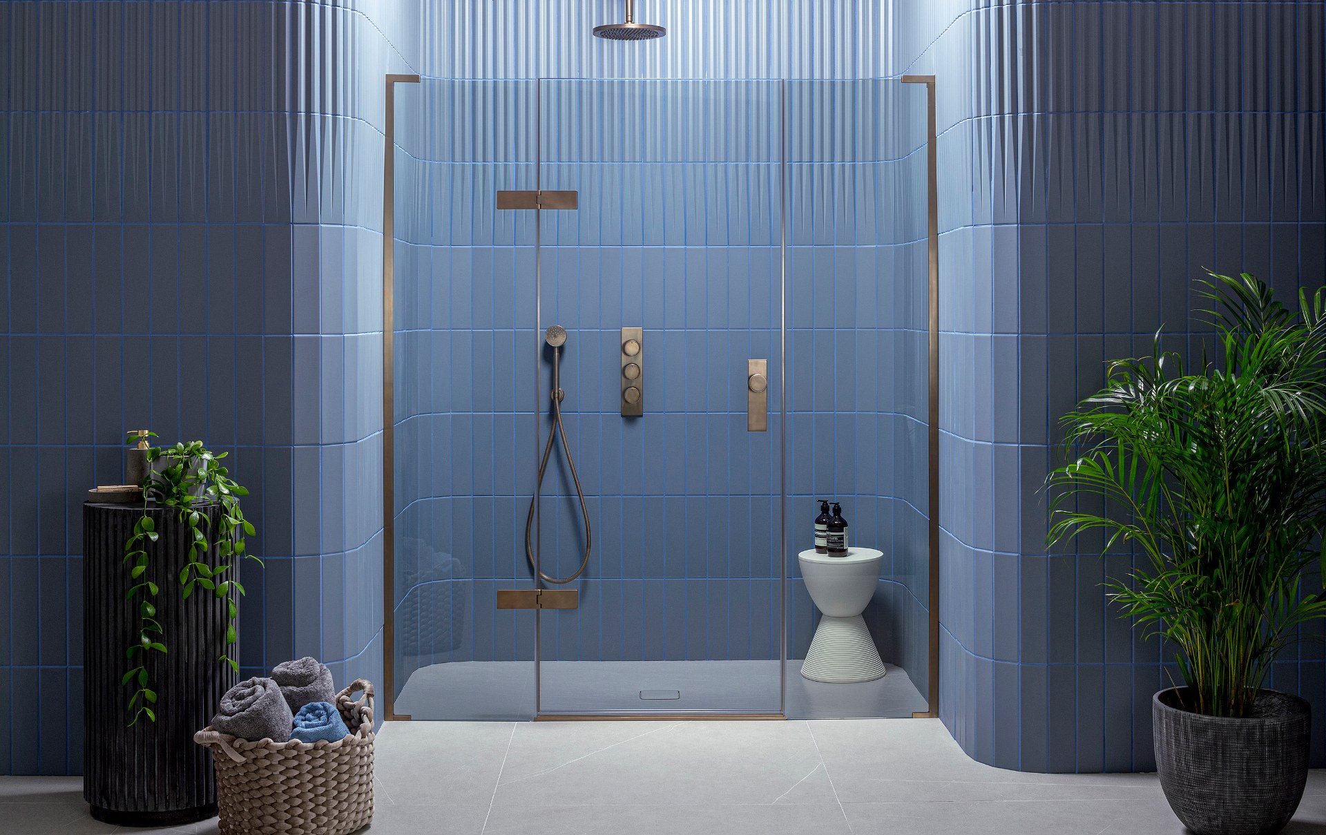Matki shower enclosure with a framed glass door against blue tiles
