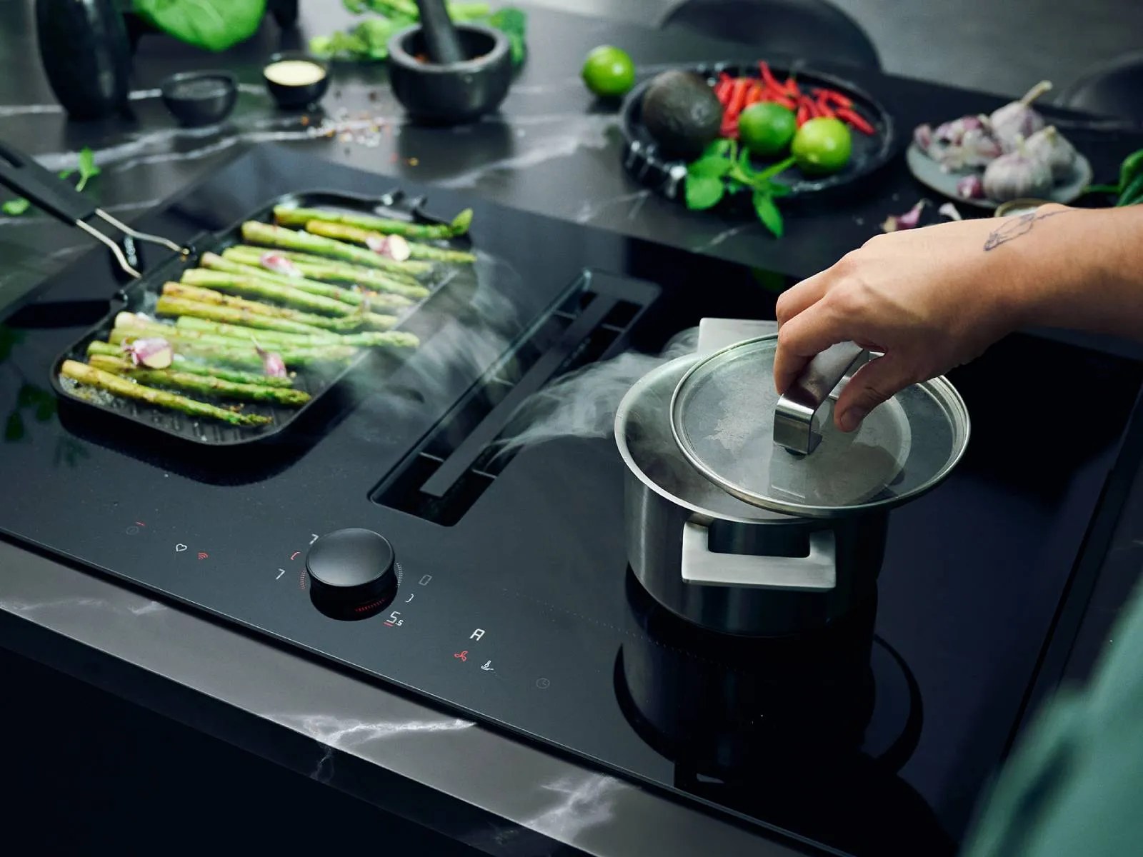 Cooking on a Neff induction hob with a venting extractor