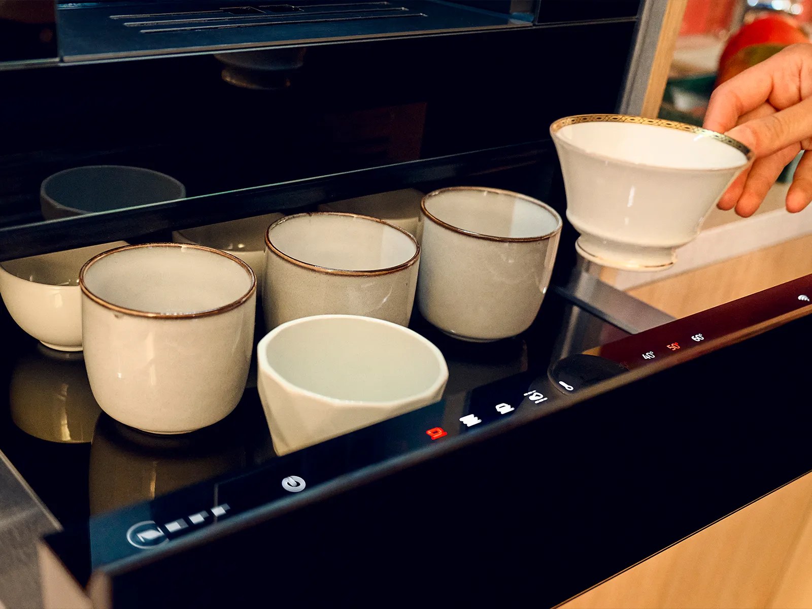 Neff warming drawer holding bowls and crockery