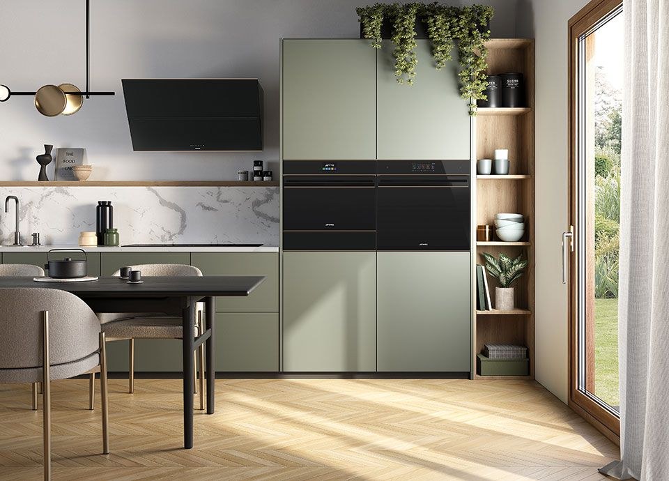 Two Smeg built-in ovens in a sage green kitchen